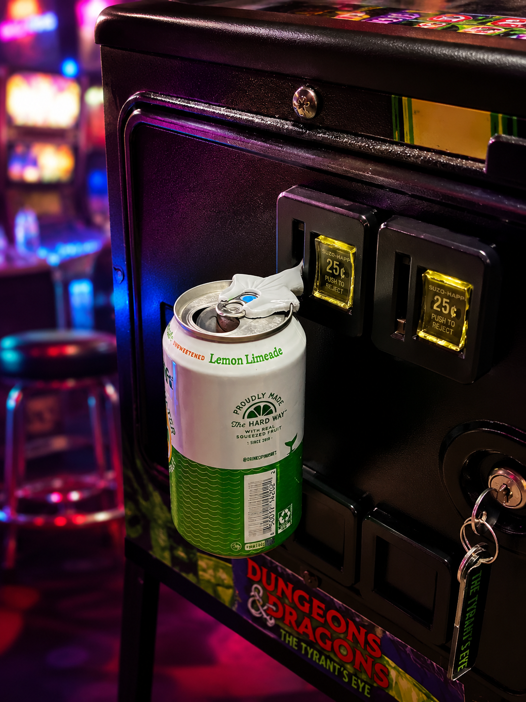Coinzy holding a can from an arcade quarter slot in use
